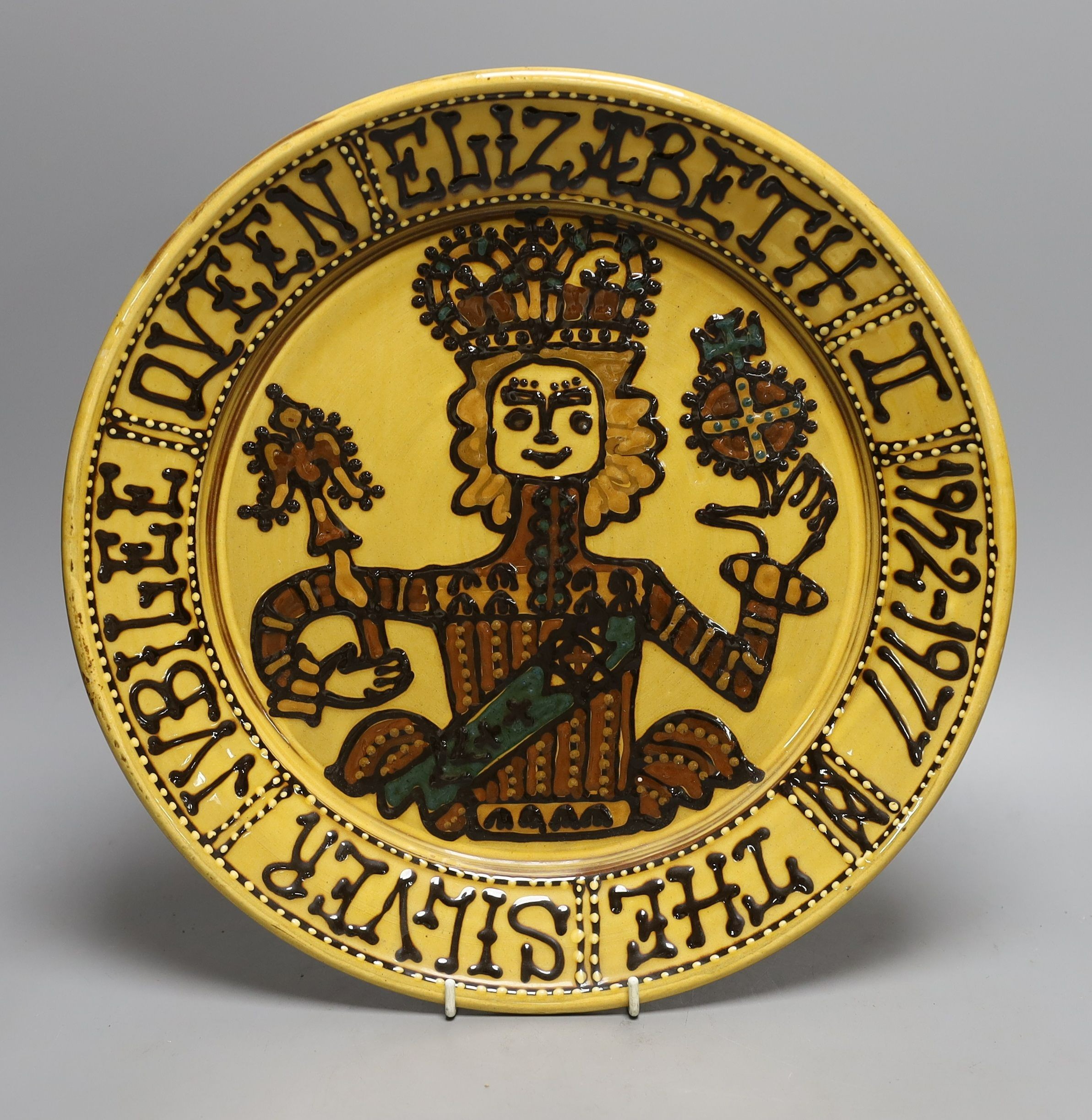 A Queen Elizabeth II silver jubilee commemorative large slipware charger, 1977, 36 cms diameter.